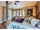 Opulent main bedroom features a four-poster bed, seating area, and outdoor access through French doors at 8698 Waterford Bend St, Las Vegas, NV 89123