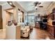 Cozy office space with wood floors, a large desk, a built-in bookcase, and comfortable seating at 8698 Waterford Bend St, Las Vegas, NV 89123