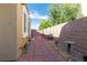 Cozy backyard features brick pavers, a tall privacy wall and mature trees at 928 Collingtree St, Las Vegas, NV 89145