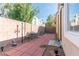 Fenced backyard with brick patio, seating, and garden decor, perfect for relaxing and entertaining at 928 Collingtree St, Las Vegas, NV 89145