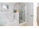 Bright bathroom with tub and separate glass door shower with neutral toned floor and gold hardware at 928 Collingtree St, Las Vegas, NV 89145