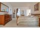 Spacious bedroom boasts a wooden bed frame with dresser and arched doorway at 928 Collingtree St, Las Vegas, NV 89145