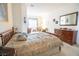 Bright bedroom with a wooden bed frame, dresser, and arched doorway at 928 Collingtree St, Las Vegas, NV 89145