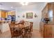 Charming dining area with a wood table, complementing cabinet, and adjacent kitchen at 928 Collingtree St, Las Vegas, NV 89145