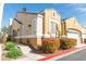 A charming two-story home with a tan exterior and landscaped front yard on a sunny day at 928 Collingtree St, Las Vegas, NV 89145