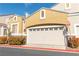Attached two-car garage with a tan door, set against a clear blue sky at 928 Collingtree St, Las Vegas, NV 89145