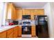 Kitchen boasts light wood cabinets, a black gas range, and modern appliances at 928 Collingtree St, Las Vegas, NV 89145