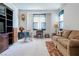 Cozy living room with neutral carpet, sofa, rocking chair, vintage style, and built-in cabinet at 928 Collingtree St, Las Vegas, NV 89145