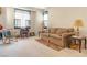 Bright living room with natural light showcases a comfortable sofa and quaint furnishings at 928 Collingtree St, Las Vegas, NV 89145