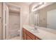 Bright bathroom featuring a sink, wooden vanity and a mirror with vanity lighting at 1009 Nawkee Dr, North Las Vegas, NV 89031