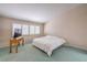 Bedroom with light walls, a white comforter on the bed, and a wooden table at 1009 Nawkee Dr, North Las Vegas, NV 89031