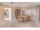 Cozy dining room with tile floors, a chandelier, and direct access to the kitchen at 1009 Nawkee Dr, North Las Vegas, NV 89031