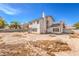 Two-story home featuring a tile roof, rear windows, and a spacious backyard at 1009 Nawkee Dr, North Las Vegas, NV 89031