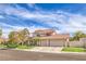 Charming two-story home boasts a three-car garage and manicured front lawn with mature trees at 1009 Nawkee Dr, North Las Vegas, NV 89031