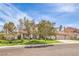 Attractive home with a well-manicured lawn, mature trees, and a three-car garage at 1009 Nawkee Dr, North Las Vegas, NV 89031