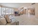 Bright living room with large windows, tile floors, and an open layout into the dining area at 1009 Nawkee Dr, North Las Vegas, NV 89031