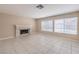 Bright living room featuring tile flooring, a fireplace, and natural light from large windows at 1009 Nawkee Dr, North Las Vegas, NV 89031