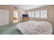 Spacious main bedroom with shutters, TV on a table, and doorway to a bathroom at 1009 Nawkee Dr, North Las Vegas, NV 89031