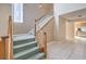 View of the carpeted staircase with white railings, leading to the upper level with tile floors at 1009 Nawkee Dr, North Las Vegas, NV 89031