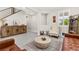 Inviting living room with wood-look floors, rustic cabinet, and staircase access at 10101 Heron Lake Ave, Las Vegas, NV 89178
