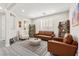 Cozy living room with comfortable seating, natural light from shuttered windows, and stylish wood-look flooring at 10101 Heron Lake Ave, Las Vegas, NV 89178