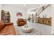 Inviting living room with stylish decor, wood-look floors, leather seating, and a staircase leading to the second floor at 10101 Heron Lake Ave, Las Vegas, NV 89178