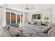 Bright living room with comfortable gray sofa, large sliding glass doors to the pool, ceiling fan, and neutral décor at 10101 Heron Lake Ave, Las Vegas, NV 89178