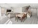 Open-concept living space featuring a dining table, comfortable seating, and a modern staircase with metal railings at 10101 Heron Lake Ave, Las Vegas, NV 89178