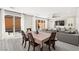 Open-concept living space featuring a dining table, comfortable seating, and a view of the pool area at 10101 Heron Lake Ave, Las Vegas, NV 89178