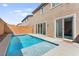 In-ground pool with baja shelf, surrounded by a brick privacy wall and concrete patio at 10101 Heron Lake Ave, Las Vegas, NV 89178