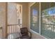 Cozy balcony features a quaint table and chairs perfect for relaxing and enjoying the outdoor view at 10550 W Alexander Rd # 2064, Las Vegas, NV 89129