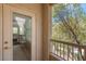 This private balcony features a glass door, railing, and views of lush greenery at 10550 W Alexander Rd # 2064, Las Vegas, NV 89129