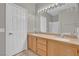 Bathroom featuring double sinks, a light wood vanity, and a door leading to shower at 10550 W Alexander Rd # 2064, Las Vegas, NV 89129