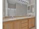 Bright bathroom features double sinks, a light wood vanity, and walk in shower at 10550 W Alexander Rd # 2064, Las Vegas, NV 89129