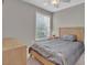 Bright bedroom features a window with blinds, complemented by wood furnishings at 10550 W Alexander Rd # 2064, Las Vegas, NV 89129