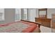 Well-lit bedroom features a wooden bed frame and dresser, accented by bright windows at 10550 W Alexander Rd # 2064, Las Vegas, NV 89129