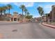 Community entrance with a gate, manicured landscaping and stately buildings at 10550 W Alexander Rd # 2064, Las Vegas, NV 89129