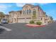 Beautiful stucco two-story home showcasing a two-car garage, manicured landscaping, and ample parking at 10550 W Alexander Rd # 2064, Las Vegas, NV 89129
