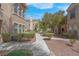 Beautiful landscaped walkway between two-story apartment buildings with desert landscaping at 10550 W Alexander Rd # 2064, Las Vegas, NV 89129