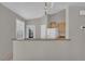 Bright kitchen featuring tile floors, a breakfast bar, and standard white appliances at 10550 W Alexander Rd # 2064, Las Vegas, NV 89129