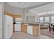 Open kitchen with tile floor, standard appliances, and view into the living room at 10550 W Alexander Rd # 2064, Las Vegas, NV 89129