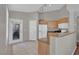 Bright kitchen featuring tile floors, a breakfast bar, and standard white appliances at 10550 W Alexander Rd # 2064, Las Vegas, NV 89129