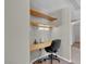 Small office nook with built-in desk, overhead shelves, and neutral color palette at 10550 W Alexander Rd # 2064, Las Vegas, NV 89129