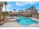 Resort-style pool with inviting hot tub, surrounded by swaying palm trees under a blue sky at 10550 W Alexander Rd # 2064, Las Vegas, NV 89129