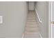Carpeted staircase leading upstairs with a handrail, ready for new memories at 10550 W Alexander Rd # 2064, Las Vegas, NV 89129