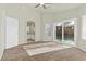Spacious main bedroom with carpet, ceiling fan, and sliding glass doors to backyard with pool at 11076 Zampino St, Las Vegas, NV 89141