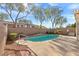 Relaxing backyard pool with stone coping, privacy wall, and lush landscaping at 11076 Zampino St, Las Vegas, NV 89141