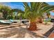 Serene backyard featuring a multi-level brick patio, lush greenery, and comfortable lounge seating at 1110 Azure Heights Pl, Las Vegas, NV 89110