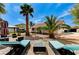 Expansive backyard featuring a brick patio, mature trees, lounge chairs, and a covered gazebo at 1110 Azure Heights Pl, Las Vegas, NV 89110