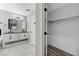 Large bathroom with double vanity and sinks, an en-suite closet, and modern lighting at 1110 Azure Heights Pl, Las Vegas, NV 89110